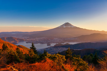 Aerial view of Mountain Fuji with morning mist or fog at sunrise in Fujikawaguchiko, Yamanashi, Japan. Mountain Fuji and Kawaguchiko lake in early morning seen from Shindo toge view point.