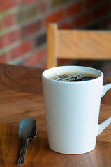 cup of coffee on wooden table