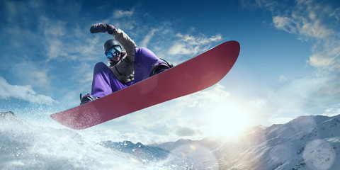 Snowboarder in action. Extreme winter sports. - obrazy, fototapety, plakaty