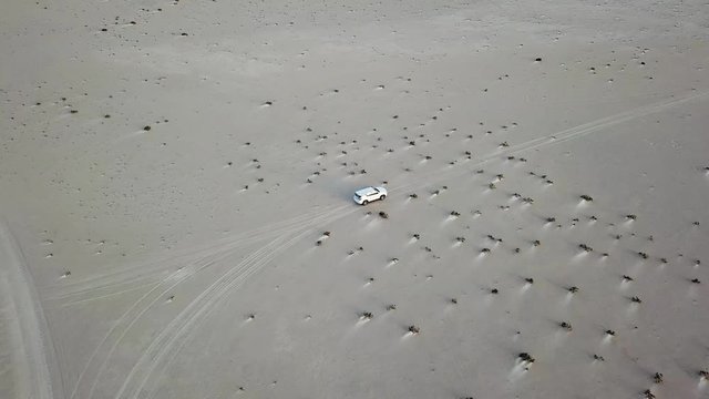 follow a car to the ocean in the backcountry aerial footage, long road, nowhere, travel restriction