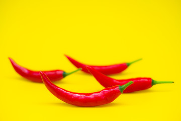 Close up red Hot chili spur pepper at yellow background