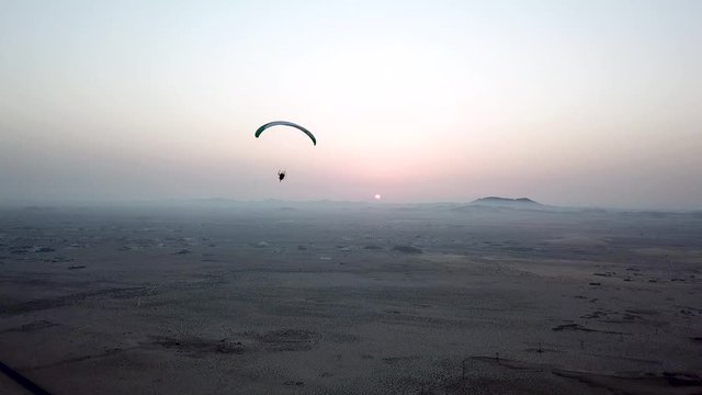 Paraglider, paramotor adventurous Sunset Extreme sports, flying like a bird, drone perspective