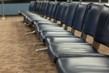 Fototapeta premium empty blue chairs in airport waiting area