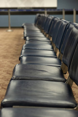 Obraz premium empty blue chairs in airport waiting area