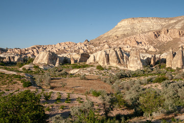 Landscape with cave houses in the rocks at Cavusin, Cappadocia, Turkey
