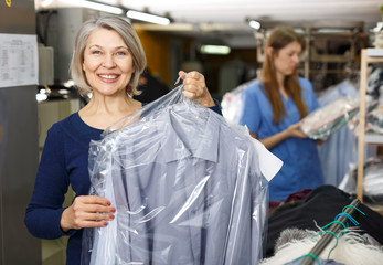 Woman holding her clean clothes
