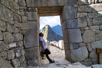 Fototapeta na wymiar Traveller at the Lost city of the Incas, Machu Picchu,Peru on top of the mountain, with the view panoramic