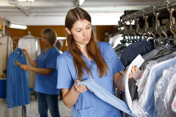 Two women working at dry-cleaning salon