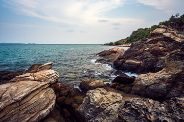 Sea rocks with wave on sunset
