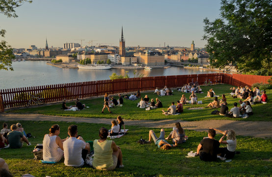 Young people picnic at sunset in the Summer in the fashionable Södermalm neighbourhood and district of Stockholm; Sweden