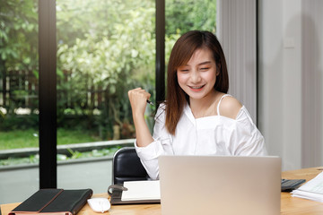 Portrait of a designer holding a pen and smile as she can come up with new ideas.