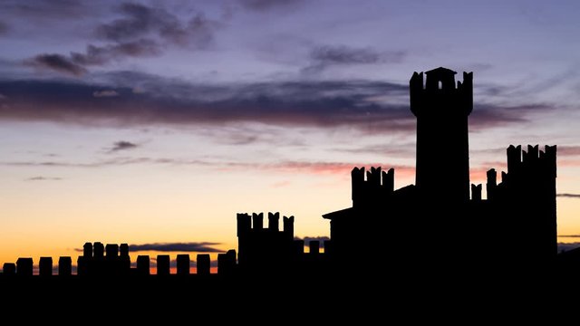 Sirmione Scaligero Castle: Time lapse at Twilight with Towers and Battlements in Silhouette, Medieval Fortress from the Scaliger Era, on Lake Garda, Italy