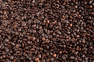 Roasted coffee beans background, arabica and robusta.