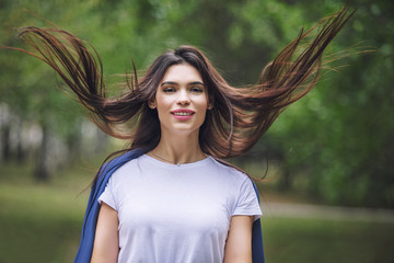 Young adult beautiful brunette girl in casual clothes happy portrait in the Park