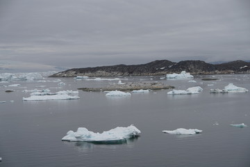 Arctic Icebergs Greenland in the arctic sea. You can easily see that iceberg is over the water surface  and below the water surface. Sometimes unbelievable that 90% of an iceberg is under water 
