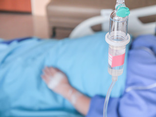 Selective focus Infusion bottle with IV, patient in hospital with saline intravenous (iv), saline into the body for treatment