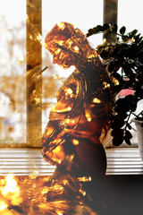 Pregnant girl silhouette with new year garlands. Double exposure.