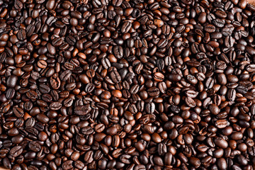 Roasted coffee beans background, arabica and robusta.