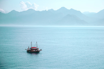 Boat with passengers. Boat trips and excursions concept. Mountains on the background.