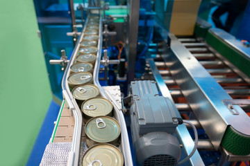 conveyor for the production of cans in factory. closed tin cans - Canned foods industry.