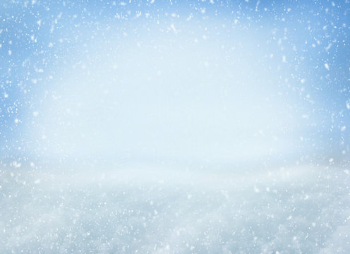 Winter Christmas background with falling snowflakes on blue background. Background for design with copy space