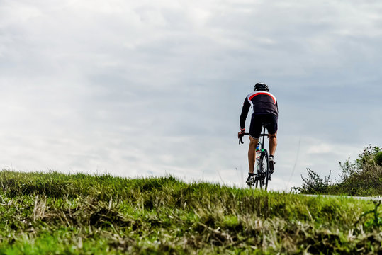 cyclist on country roads climbing a hill