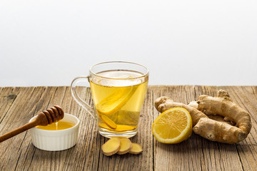 Ginger tea with lemon and honey on a wooden background. Hot healthy winter drink