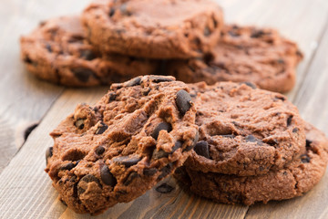 Tasty chocolate chip cookie on wooden background