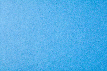 The texture of the blue surface of the cardboard closeup.