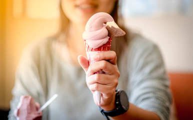 Woman holding on an ice-cream