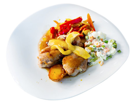 Grilled pork sirloin served with caramelized apple, stewed peppers and salad
