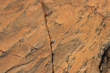 Sunlit rock with cracks possible marble for background 2