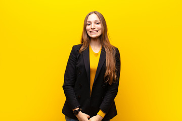 young pretty businesswoman looking happy and goofy with a broad, fun, loony smile and eyes wide...