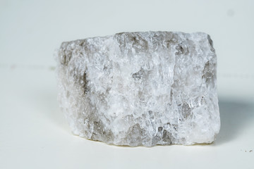 Piece of salt composed mineral, crystal stone salt isolated on white background