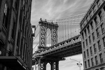 Fototapeta na wymiar View of one of the towers of the Manhattan Bridge from the streets of the DUMBO district, Brooklyn, NYC black and white