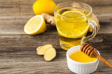 Ginger tea with lemon and honey on a wooden background. Hot healthy winter drink