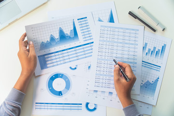 Fototapeta businessman working data document graph chart report marketing research development  planning management strategy analysis financial accounting. Business  office concept. obraz