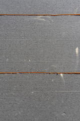 Wärmedämmplatten in grau und Klebstoff in orange zur Wärmeisolierung von Wohngebäuden in Nahaufnahme, auch als Hintergrund zu verwenden