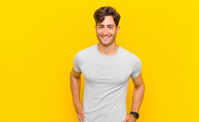  smiling happily with a hand on hip and confident, positive, proud and friendly attitude