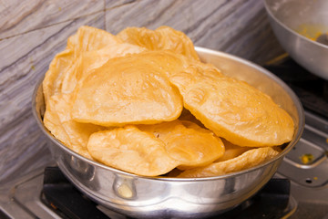 puri or poori indian delicious fast food made of flour fried with vegetable oil