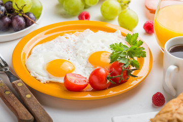 Homemade breakfast with sunny side up fried egg croissant toast coffee fruits vegetable and orange juice in top view with copy space. Delicious homemade american breakfast concept for background. Amer