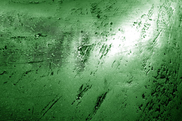 Part of bronze sculpture close-up in green tone.