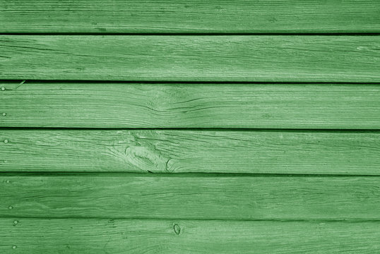 Old grungy wooden planks background in green color.
