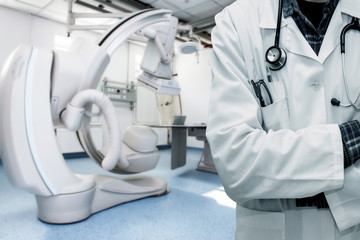 Abstract image of doctor in a white coat with a statostcope on the background of an angiograph in a modern hospital for heart surgery