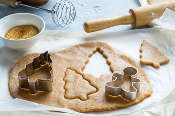 Cooking Christmas gingerbread. Raw dough and cutters for the holiday cookies. Christmas family...