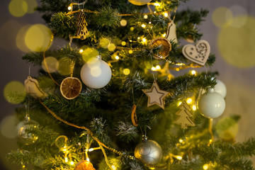 close up of decorated Christmas tree with balls and lights