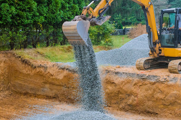 Industrial construction of foundation excavator moving gravel for building