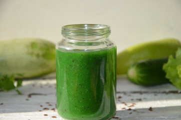 Detox diet. Green smoothie with different vegetables on white wooden background copy space. diet vegitarians healthy low calorie food. salad, greens, green apple chia or flax linen seeds