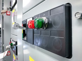 Industrial electrical supply board, status indicator lights and switch breaker on.