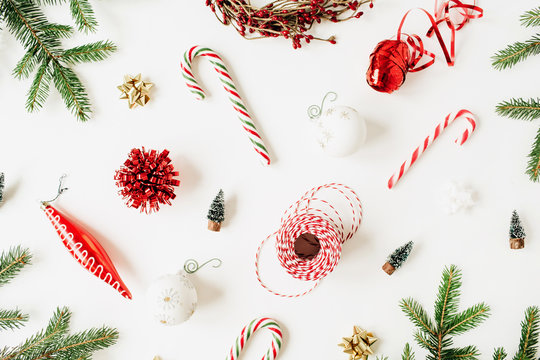 Christmas / New Year Composition With Fir Branches, Christmas Baubles, Sweets, Decorations On White Background. Flat Lay, Top View Colorful Festive Holiday Concept.